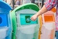 Man hand holding and putting plastic bottle waste into garbage trash Royalty Free Stock Photo