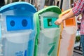 Man hand holding and putting plastic bottle waste into garbage trash Royalty Free Stock Photo