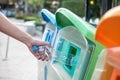 Man hand holding and putting plastic bottle waste into garbage trash Royalty Free Stock Photo