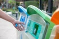 Man hand holding and putting plastic bottle waste into garbage trash Royalty Free Stock Photo