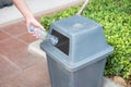 Man hand holding and putting plastic bottle waste into garbage trash Royalty Free Stock Photo