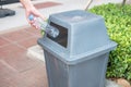 Man hand holding and putting plastic bottle waste into garbage trash Royalty Free Stock Photo