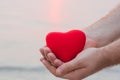 Man hand holding red heart on the beach Royalty Free Stock Photo