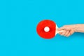 Man hand holding a red ping pong paddle with a white ball Royalty Free Stock Photo