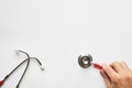 Man hand holding a red stethoscope - medical diagnostic device for auscultation listening of sounds coming from the heart, Royalty Free Stock Photo