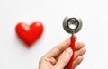 Man hand holding a red stethoscope - medical diagnostic device for auscultation listening of sounds coming from the heart, Royalty Free Stock Photo