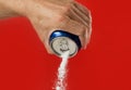 Man hand holding refresh drink can pouring sugar stream in sweet and calories content of soda and energy drinks