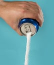 Man hand holding refresh drink can pouring sugar stream in sweet and calories content of soda and energy drinks Royalty Free Stock Photo