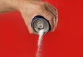 Man hand holding refresh drink can pouring sugar stream in sweet and calories content of soda and energy drinks