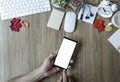 Man hand holding smartphone with blank screen on office desk Royalty Free Stock Photo