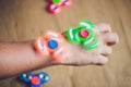 A man hand holding hand spinner or fidget spinner over wooden background Royalty Free Stock Photo