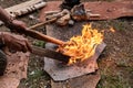 Man hand holding sticks in straw with fire