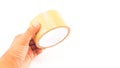 Man hand holding thick brown plastic tape with big core