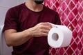 Man hand holding a toilet paper