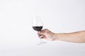 Man hand holding a wine glass on a gray background