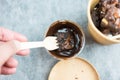 Man hand holding wood fork with chocolate brownies dipping chocolate sauce Royalty Free Stock Photo