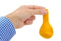 Man hand holding a yellow deflated balloon on Royalty Free Stock Photo