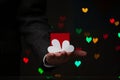 Man hand holds box and hearts made of paper Royalty Free Stock Photo