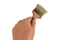 Man hand holds a brush. Isolated closeup on white background. Concept of painting decoration, home improvement or renovation. Royalty Free Stock Photo