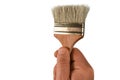 Man hand holds a brush. Isolated closeup on white background. Concept of painting decoration, home improvement or renovation. Royalty Free Stock Photo