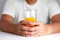 Man hand holds orange juice Healthy drink.