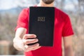 Man hand Holy Bible in nature Royalty Free Stock Photo