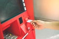 Man hand inserting debit or credit card to withdraw money with A Royalty Free Stock Photo