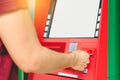 Man hand inserting debit or credit card to withdraw money with A Royalty Free Stock Photo