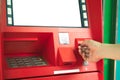 Man hand inserting debit or credit card to withdraw money with A Royalty Free Stock Photo
