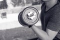 Man hand lifting the steel dumbbell in a gym muscle-building black and white image, life and fitness concept with copy space Royalty Free Stock Photo