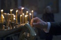 Man hand lighting candles in a church. Royalty Free Stock Photo