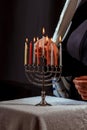 Man hand lighting candles in menorah hanukka lights candles