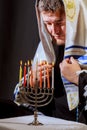 man hand lighting candles in menorah on table served for hanukka Royalty Free Stock Photo