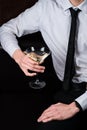 A man drinking martini cocktail with olives Royalty Free Stock Photo