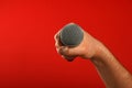 Man hand with microphone over red background Royalty Free Stock Photo