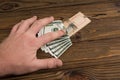 A man hand and a mousetrap with bait money dollars banknotes Royalty Free Stock Photo