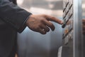 Man hand office worker in a business suit press the elevator button with his finger. Businessman in an office center