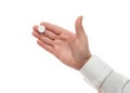 Man hand with one big white pill isolated on white background. White shirt, business style. Medicament and food supplement for Royalty Free Stock Photo