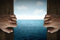 Man hand open door into the sea Royalty Free Stock Photo