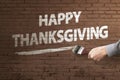 Man hand with paintbrush writing Happy Thanksgiving message Royalty Free Stock Photo