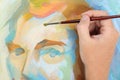 Man hand painting abstract portrait