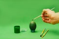 Man hand paints Easter egg with brush Royalty Free Stock Photo
