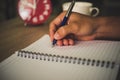 Man hand with pen writing on notebook. Royalty Free Stock Photo