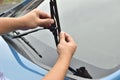 Man hand picking up windscreen wiper