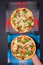 Man hand pizza. Top view with delicious with mushrooms ham and Basil pizza. vertical photo Royalty Free Stock Photo