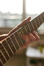 Man hand playing riffs on electric guitar at home Royalty Free Stock Photo