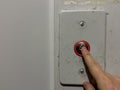 A man hand presses the elevator call button in an old house, silver elevator Royalty Free Stock Photo