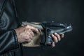 Man hand pulls a gun from a leather holster Royalty Free Stock Photo