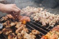 Man hand put bbq steaks and meat grilled on brazier Royalty Free Stock Photo