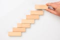 Man hand put wooden blocks in the shape of a staircase Royalty Free Stock Photo